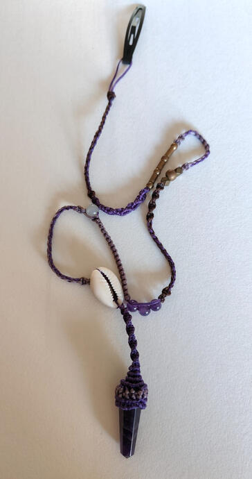Elevate your everyday hair routine with this one-of-a-kind handwoven hair clip. Designed for both beauty and intention, it combines the calming energy of natural amethyst with the free-spirited charm of a tiny seashell — all wrapped in rich purple waxed co
