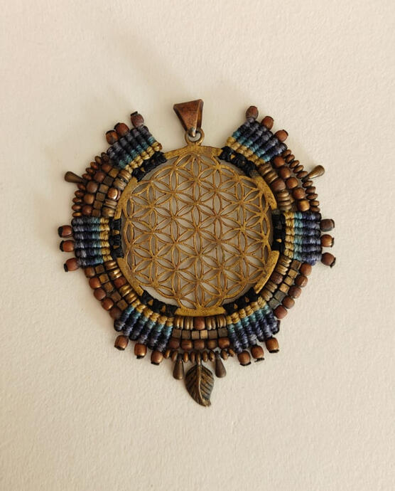 Dive into the depths of cosmic consciousness with this Flower of Life pendant, now reimagined in deep indigo, teal, and antique bronze. The Sacred Geometry centerpiece symbolizes universal creation — while the handwoven waxed thread (inspired by South Ame