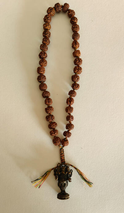 Invite Wisdom and Remove Obstacles on Your Journey This isn't just a hanging ornament; it's a wearable piece of spiritual art. Sacred Materials: Crafted with natural Rudraksha beads, known for their grounding and meditative properties. Divine Symbolism: