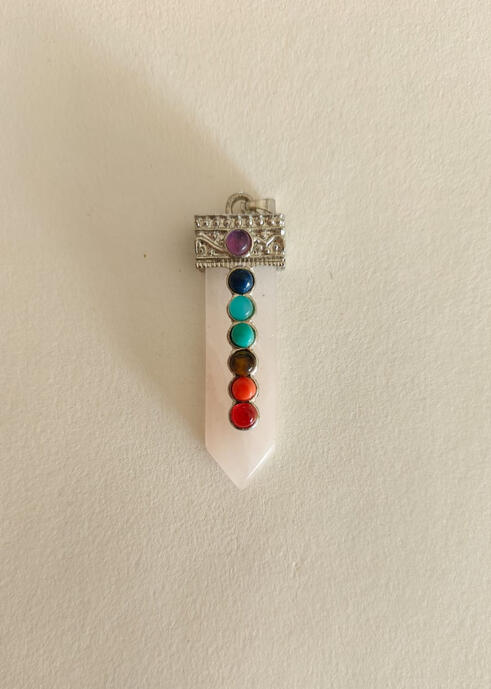 Open your heart and balance your energy. This beautiful pendant features a natural Rose Quartz column, known as the Stone of Unconditional Love, embedded with the seven chakra stones. It’s a powerful talisman for emotional healing, attracting love, and al
