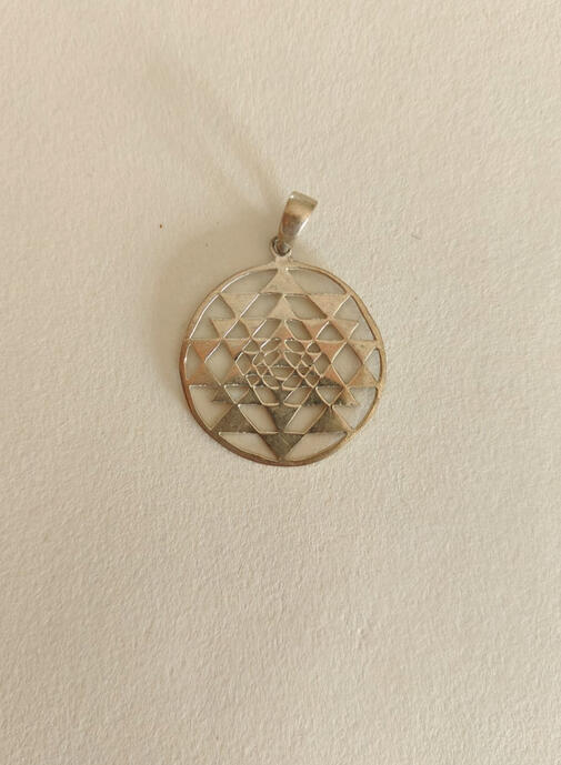 Powerful Symbolism: The interlocking triangles represent the dynamic interplay of energy and consciousness, while the central Bindu signifies the source of creation. Manifestation & Prosperity: Revered as a potent talisman, the Sri Yantra is believed to r